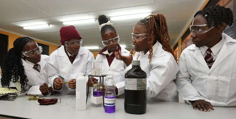 The Forte Secondary School fulfils an important role of educating 2,400 learners. (Image source: Bell Equipment) South African students dressed in laboratory dress.