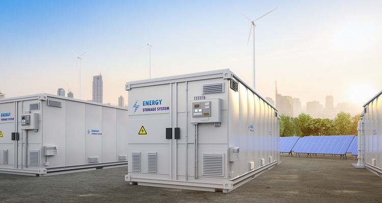An image of an energy storage system in front of wind turbines and a skyline. 