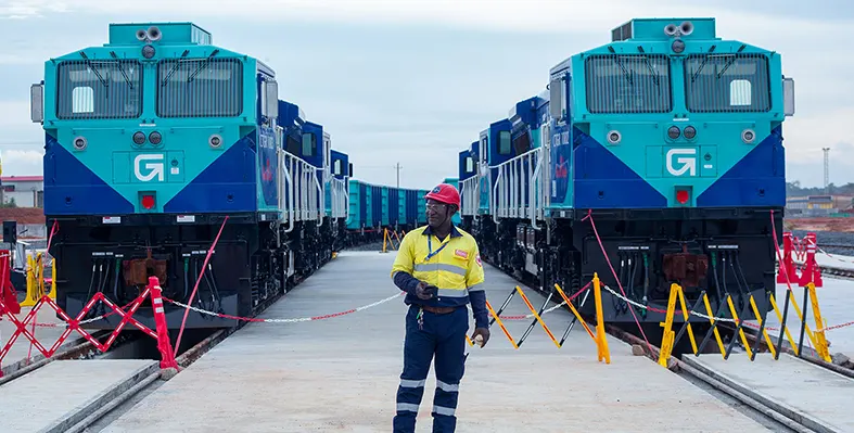 Locomotives power Guinea’s progress. (Image source: SimFer) Man_with_Locomotives