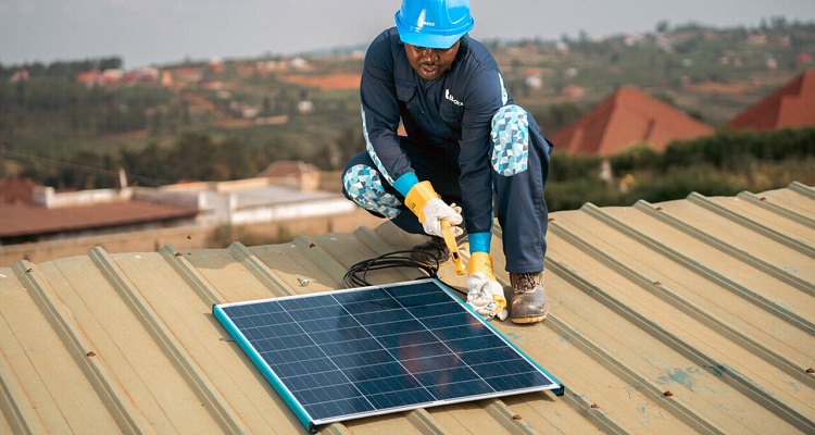 An engineer installing a solar panel on a roof.